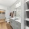 Bathroom with a big mirror, a shower, a toilet, and white countertops