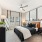 Large bedroom with large pictures on the wall and  windows