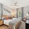 Large bedroom with a nightstand, a dresser, and windows