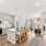 Kitchen island with hanging light fixture connected to a living room