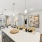 Kitchen island with hanging light fixture connected to a living room