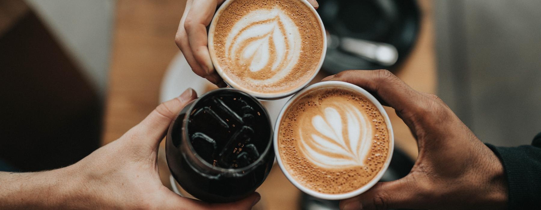 a person holding a cup of coffee